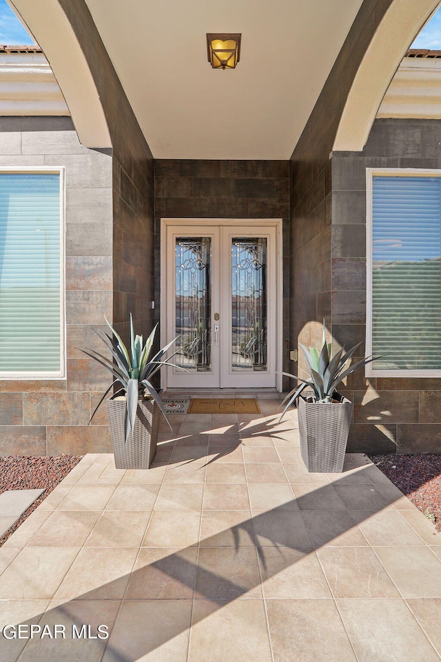 property entrance featuring french doors and a patio area