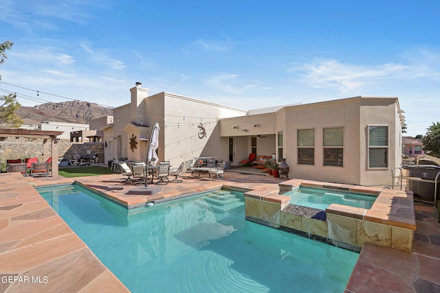 view of pool featuring an in ground hot tub and a patio area