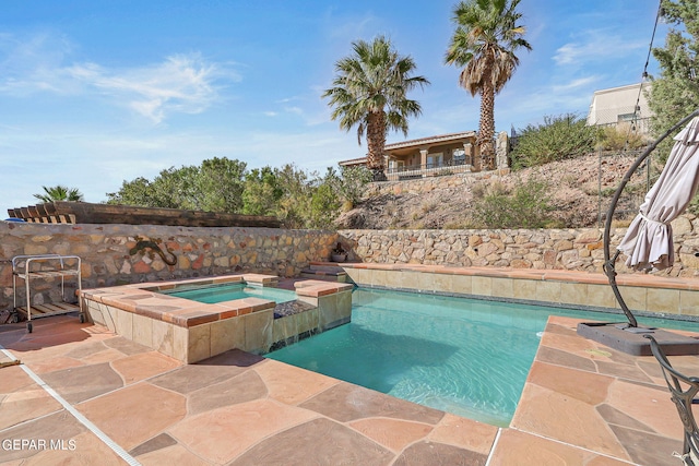 view of pool with an in ground hot tub and a patio area