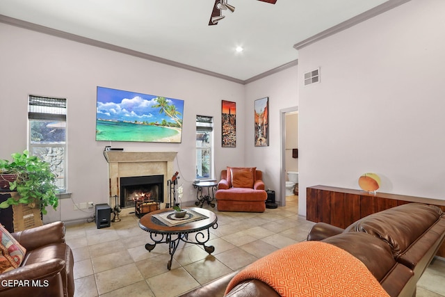 living room featuring crown molding and light tile patterned floors