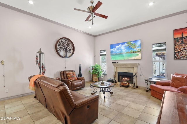 living room with a fireplace, ornamental molding, light tile patterned flooring, and a healthy amount of sunlight