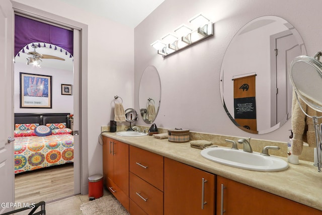 bathroom with wood-type flooring, vanity, and ceiling fan