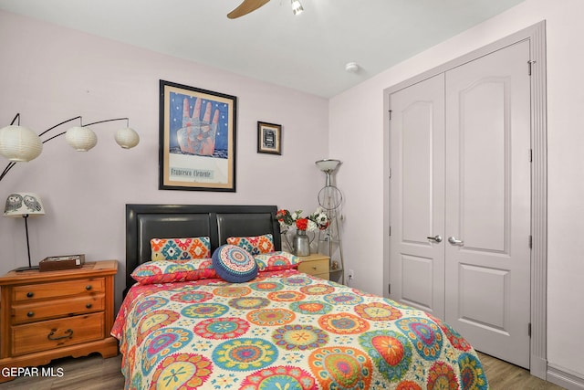 bedroom featuring a closet, hardwood / wood-style flooring, and ceiling fan