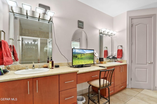 bathroom with tile patterned floors, a shower with door, and vanity