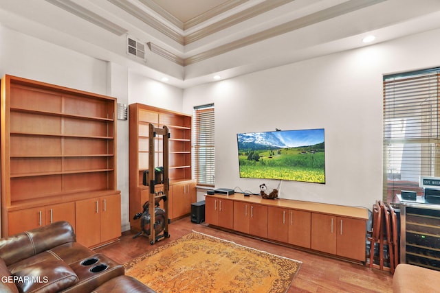 living room featuring ornamental molding and light hardwood / wood-style flooring