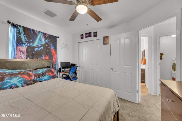 carpeted bedroom with ceiling fan, washer / clothes dryer, and a closet