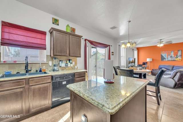 kitchen with a kitchen island, sink, pendant lighting, black dishwasher, and light tile patterned floors