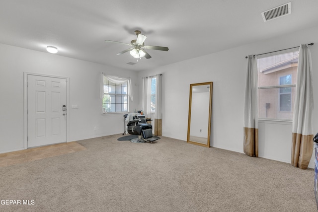 misc room featuring light carpet and ceiling fan