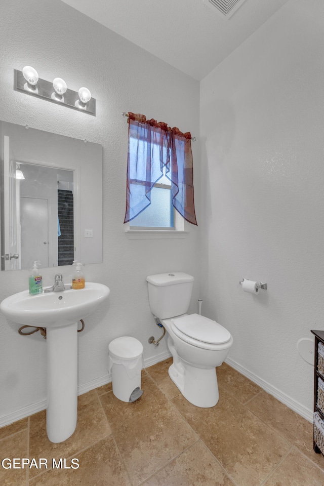 bathroom with tile patterned flooring and toilet