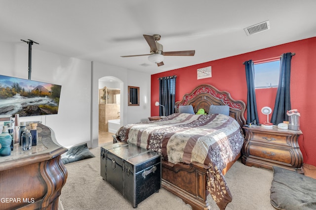 bedroom with light carpet, ceiling fan, and ensuite bath