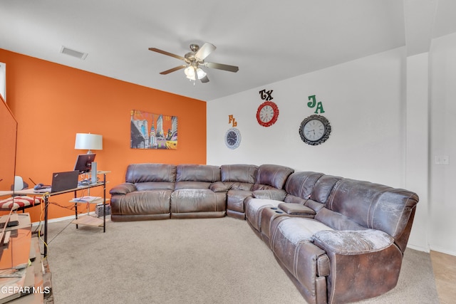 carpeted living room featuring ceiling fan