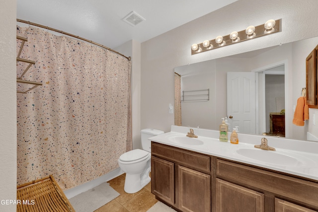 bathroom with vanity, tile patterned flooring, toilet, and curtained shower