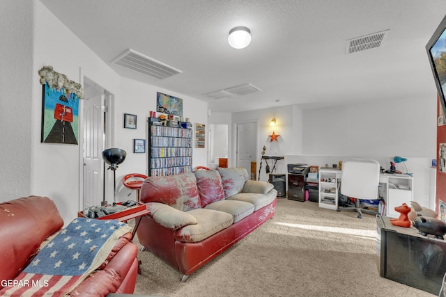 living room with a textured ceiling and carpet flooring