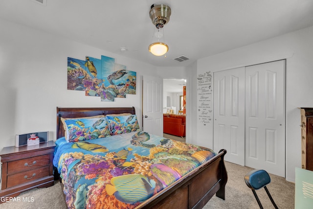 bedroom with light colored carpet and a closet