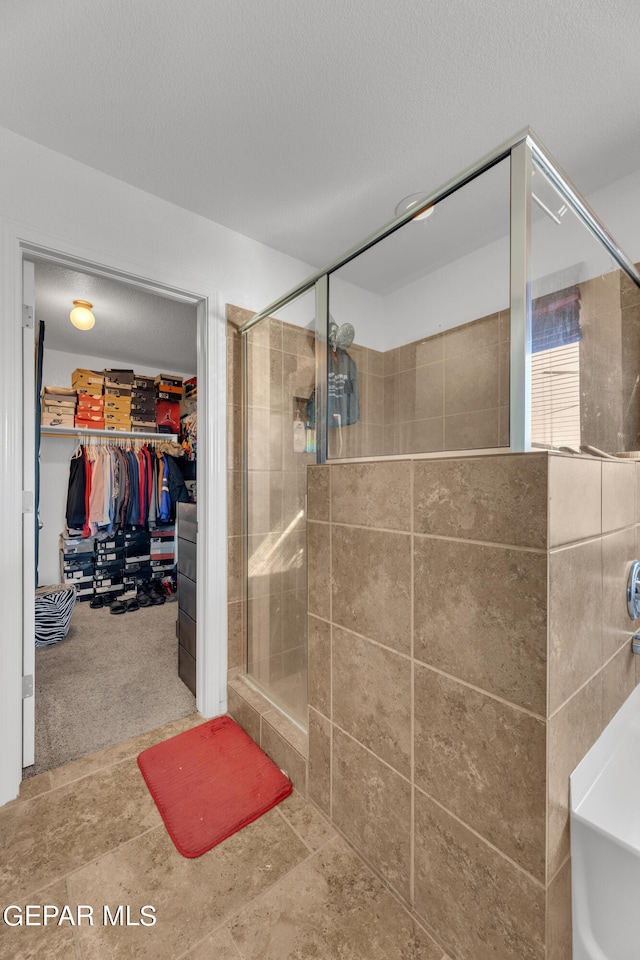 bathroom with shower with separate bathtub and a textured ceiling