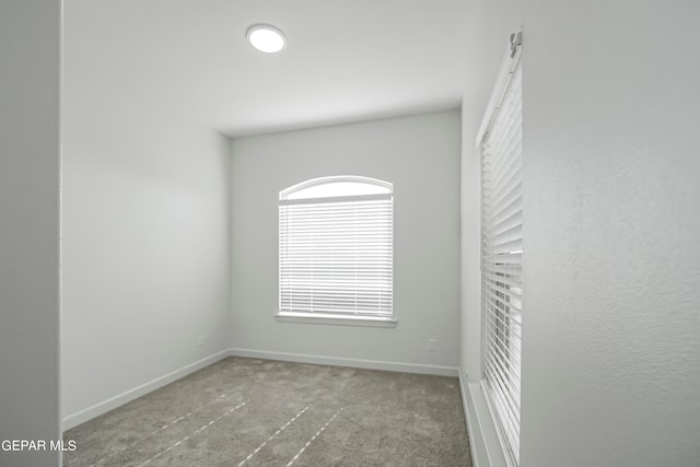 unfurnished room featuring light colored carpet