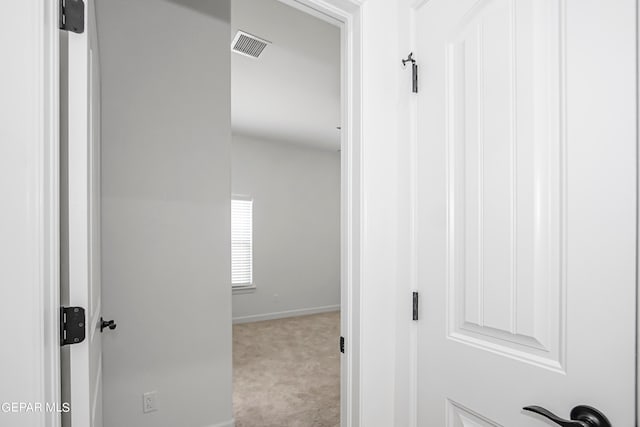 corridor with light colored carpet