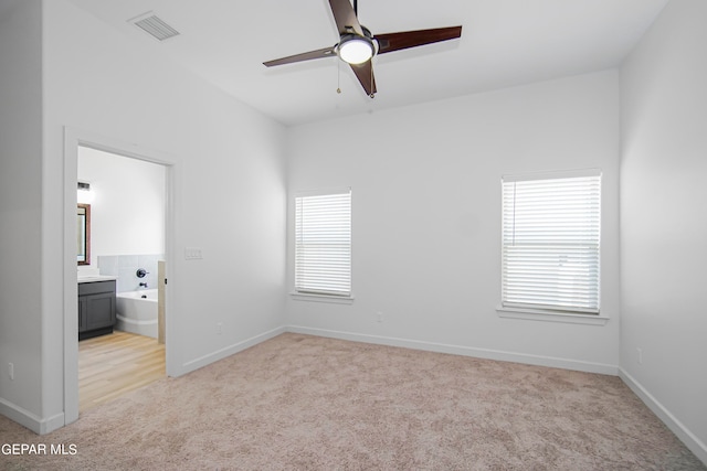 carpeted empty room featuring ceiling fan