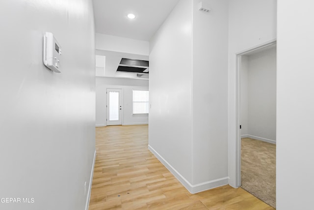 corridor with light wood-type flooring