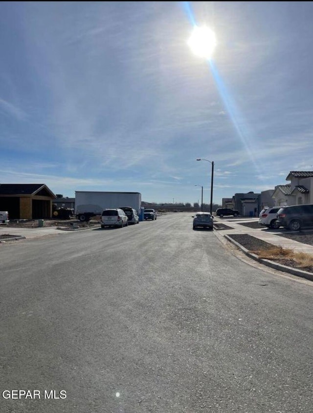 12044 Cotton Cloud Way, Socorro, TX 79927 - view of road with sidewalks, curbs, and street lighting