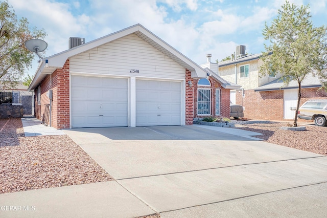 view of front facade featuring cooling unit and a garage