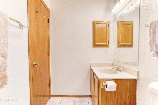 bathroom featuring toilet, tile patterned flooring, and vanity