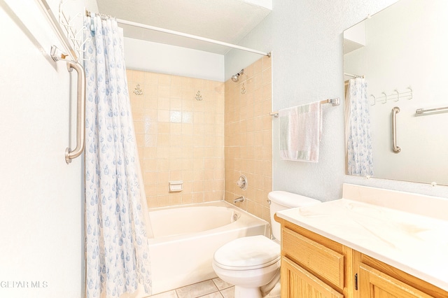 full bathroom featuring vanity, shower / bath combination with curtain, tile patterned floors, toilet, and a textured ceiling