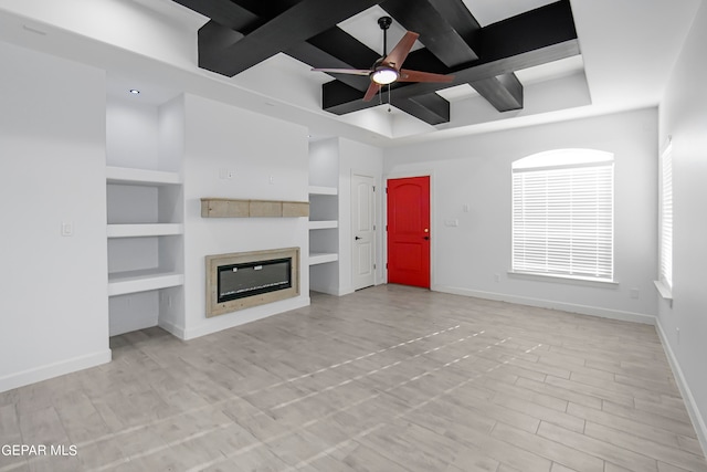 unfurnished living room featuring ceiling fan, built in shelves, and light hardwood / wood-style floors