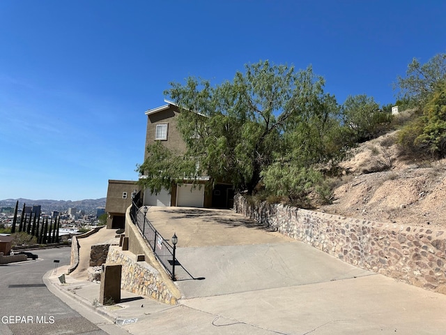 view of front of house featuring a garage and a mountain view