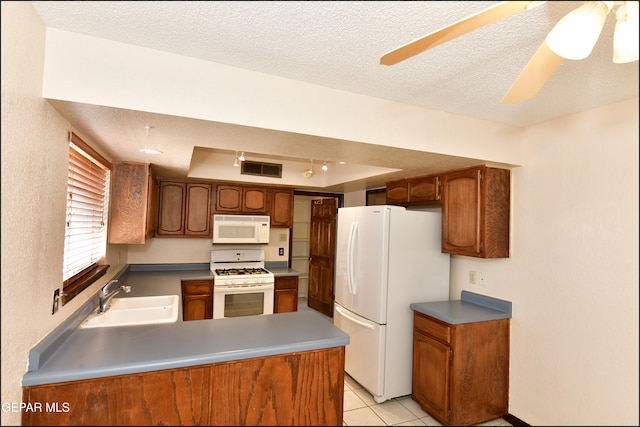 kitchen featuring white appliances, sink, a textured ceiling, and ceiling fan