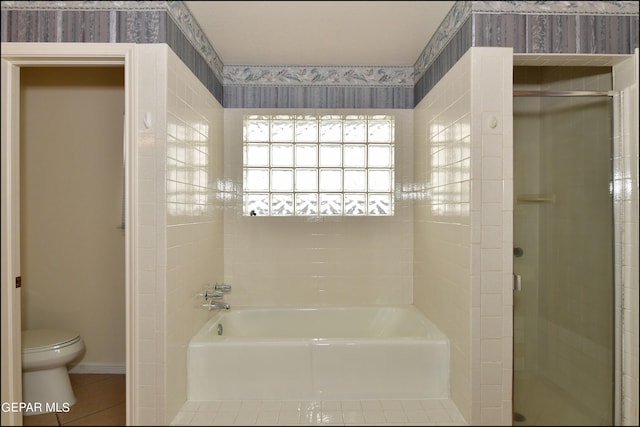 bathroom with shower with separate bathtub, toilet, and tile patterned floors