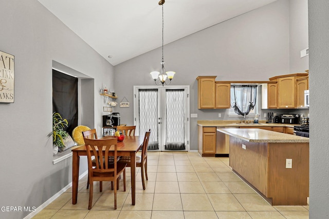 kitchen featuring black range with gas stovetop, hanging light fixtures, high vaulted ceiling, and light tile patterned floors