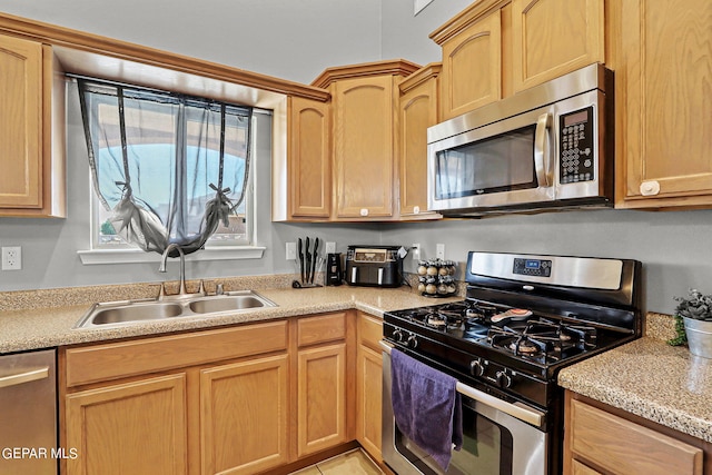 kitchen featuring sink, stainless steel appliances, and light brown cabinets