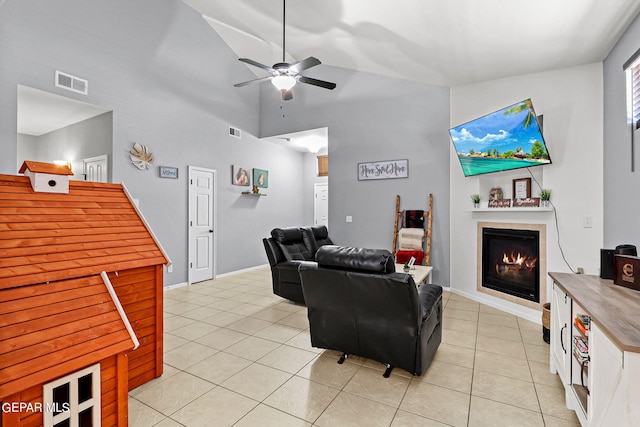 tiled living room with high vaulted ceiling and ceiling fan