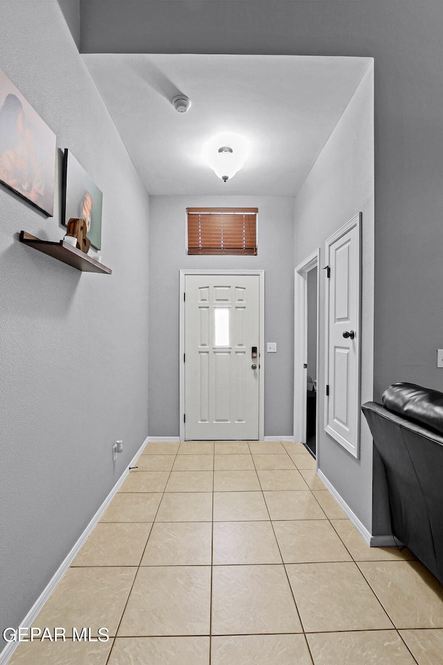 foyer entrance with light tile patterned floors