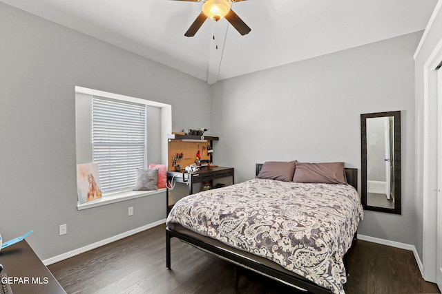 bedroom with ceiling fan, vaulted ceiling, and dark hardwood / wood-style flooring