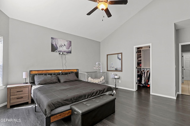 bedroom with high vaulted ceiling, a spacious closet, ceiling fan, a closet, and dark hardwood / wood-style flooring