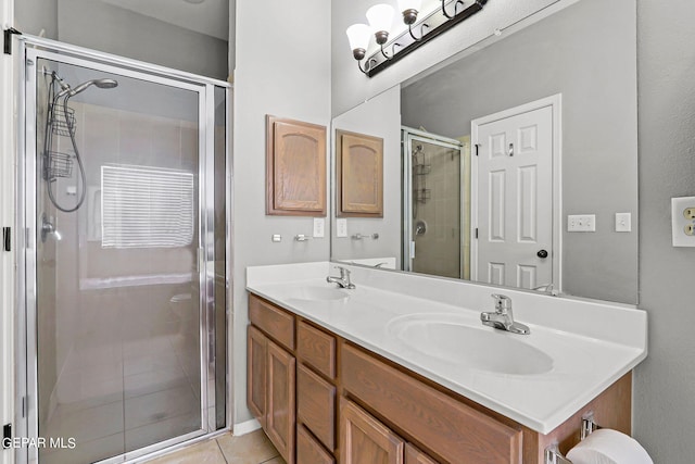 bathroom with an enclosed shower, tile patterned floors, and vanity