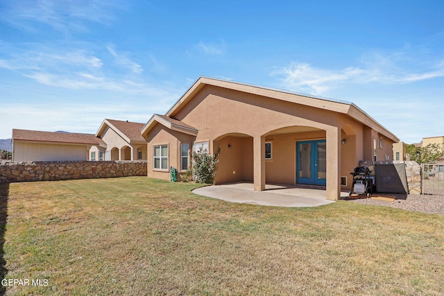 back of property featuring a yard and a patio area