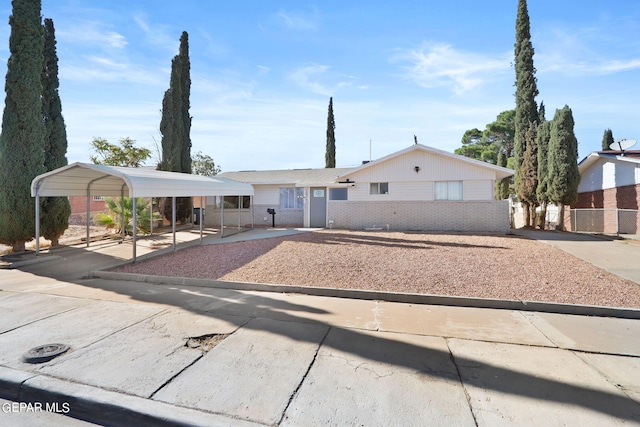 ranch-style home featuring a carport