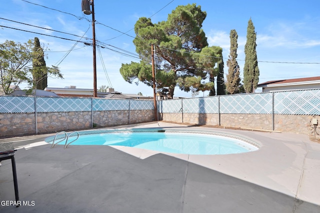 view of pool with a patio, a fenced in pool, and a fenced backyard