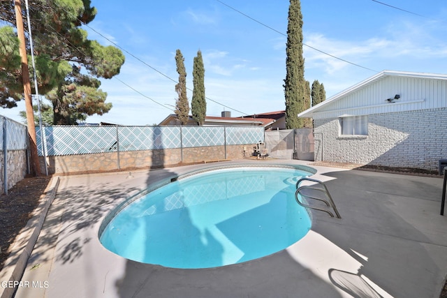 view of pool featuring a patio area, a fenced in pool, and a fenced backyard