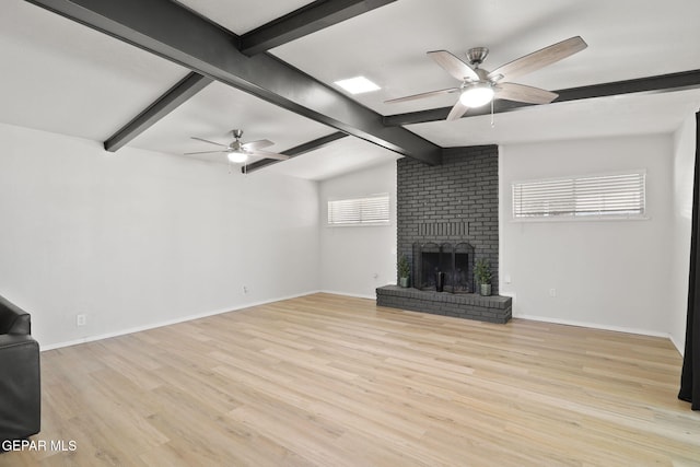 unfurnished living room featuring light wood finished floors, a brick fireplace, baseboards, and a ceiling fan