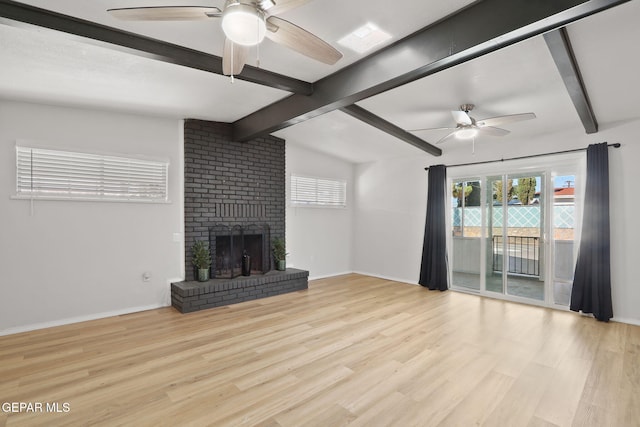 unfurnished living room with lofted ceiling with beams, a ceiling fan, and wood finished floors