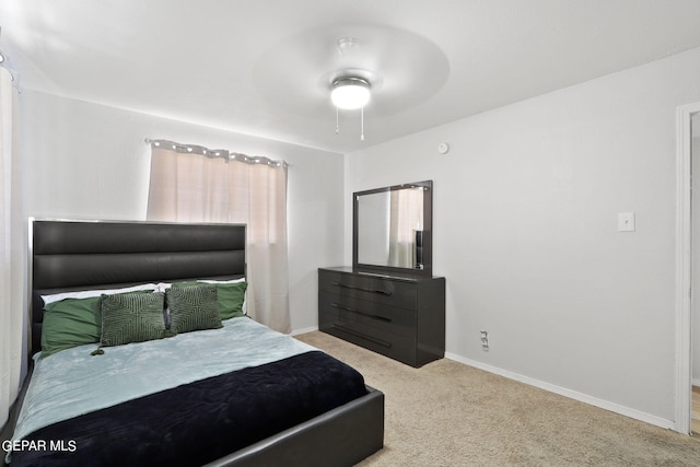 carpeted bedroom with baseboards and ceiling fan