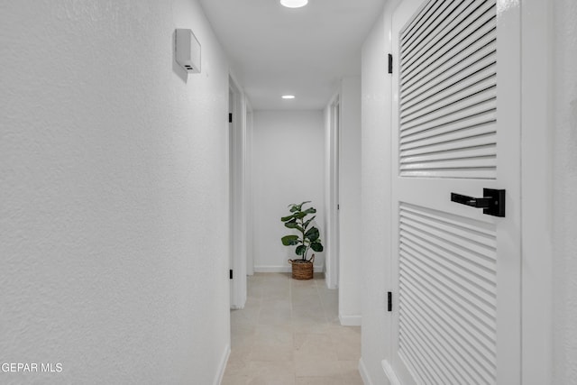 corridor with light tile patterned floors