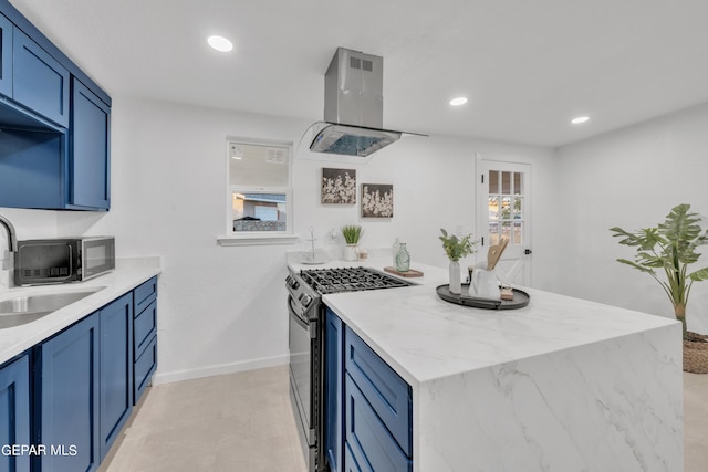 kitchen with blue cabinets, stainless steel gas range oven, sink, and extractor fan