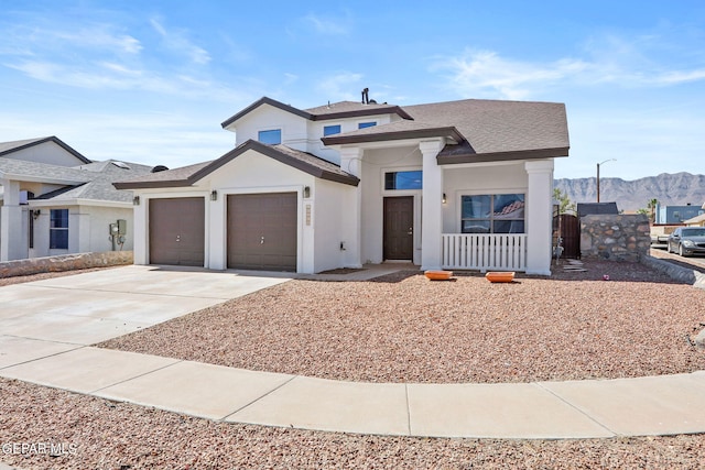 view of front of home featuring a garage and a mountain view