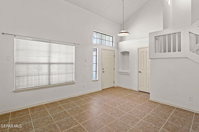 tiled foyer entrance with high vaulted ceiling