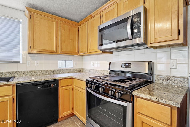 kitchen featuring decorative backsplash, a textured ceiling, stainless steel appliances, and light stone counters